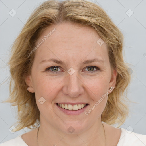 Joyful white adult female with medium  brown hair and blue eyes