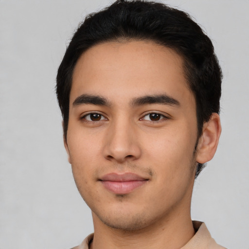 Joyful latino young-adult male with short  black hair and brown eyes