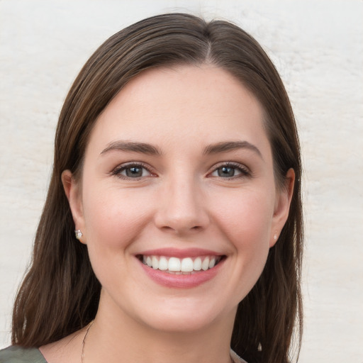 Joyful white young-adult female with long  brown hair and grey eyes