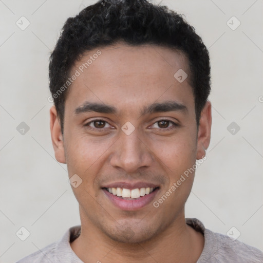 Joyful latino young-adult male with short  brown hair and brown eyes