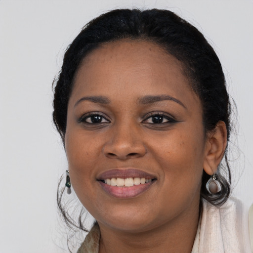 Joyful black young-adult female with long  black hair and brown eyes