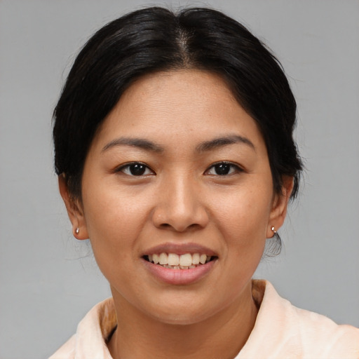 Joyful asian young-adult female with medium  brown hair and brown eyes