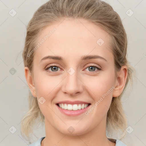 Joyful white young-adult female with medium  brown hair and blue eyes