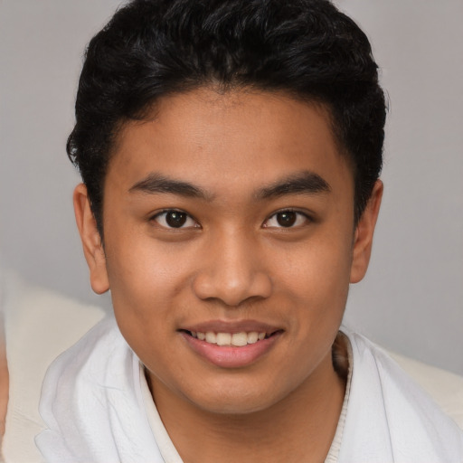 Joyful latino young-adult male with short  brown hair and brown eyes