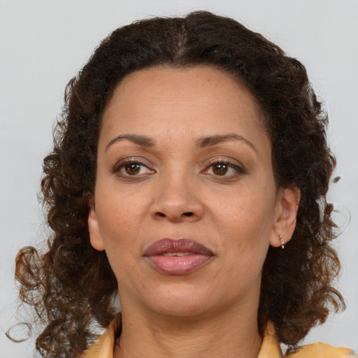 Joyful black adult female with medium  brown hair and brown eyes