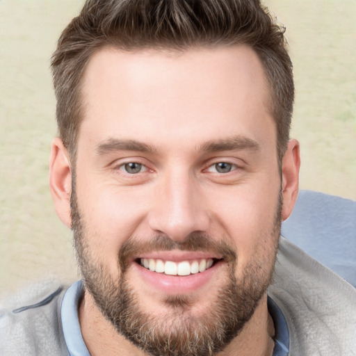 Joyful white young-adult male with short  brown hair and brown eyes