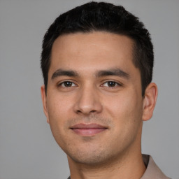 Joyful white young-adult male with short  black hair and brown eyes