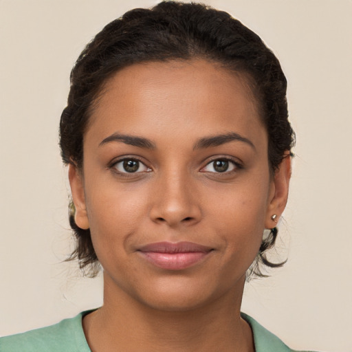 Joyful latino young-adult female with short  brown hair and brown eyes