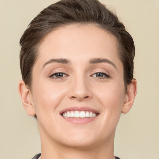 Joyful white young-adult female with short  brown hair and brown eyes