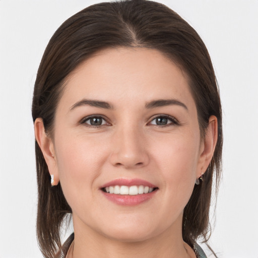 Joyful white young-adult female with medium  brown hair and brown eyes