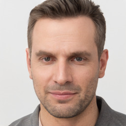 Joyful white adult male with short  brown hair and grey eyes