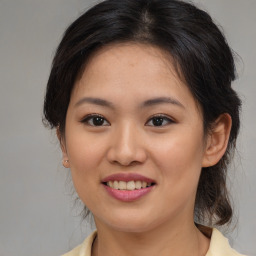 Joyful asian young-adult female with medium  brown hair and brown eyes