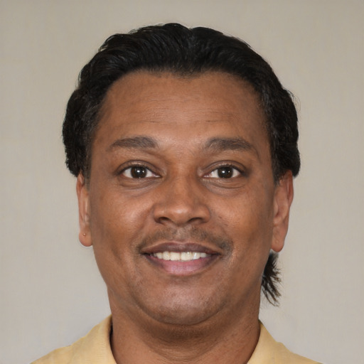 Joyful latino adult male with short  brown hair and brown eyes