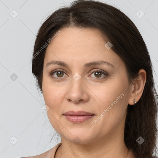 Joyful white adult female with long  brown hair and brown eyes