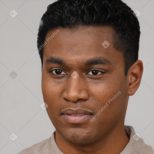Joyful black young-adult male with short  black hair and brown eyes
