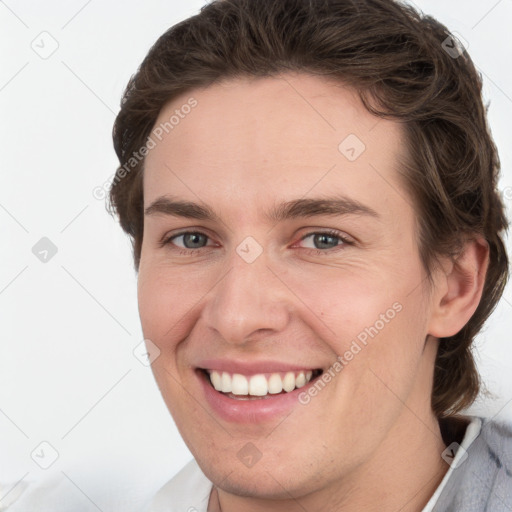 Joyful white young-adult female with short  brown hair and grey eyes