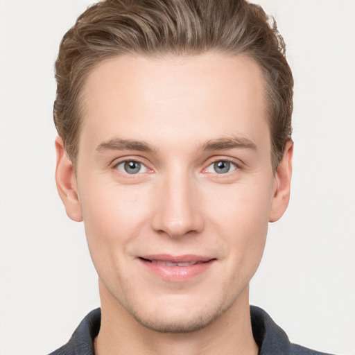 Joyful white young-adult male with short  brown hair and grey eyes