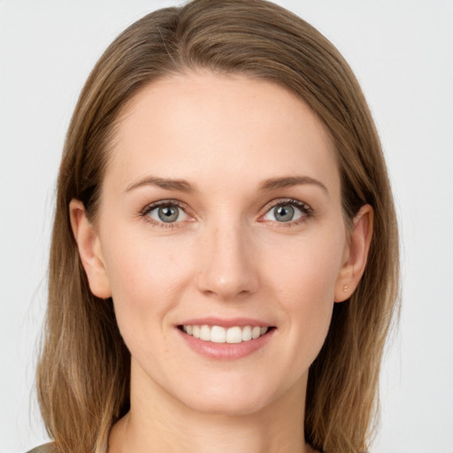 Joyful white young-adult female with long  brown hair and grey eyes