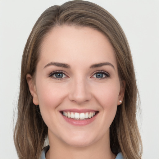 Joyful white young-adult female with long  brown hair and grey eyes