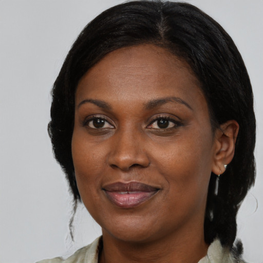 Joyful black adult female with medium  black hair and brown eyes