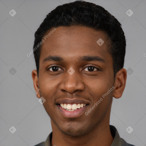 Joyful black young-adult male with short  black hair and brown eyes