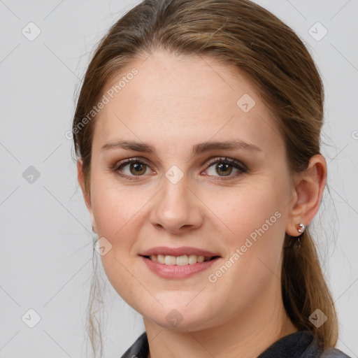 Joyful white young-adult female with medium  brown hair and grey eyes