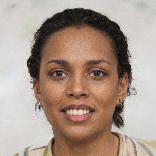 Joyful black young-adult female with short  brown hair and brown eyes