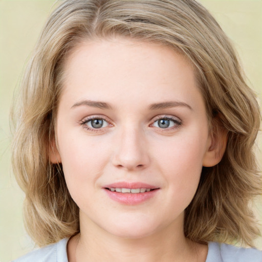 Joyful white young-adult female with medium  brown hair and blue eyes