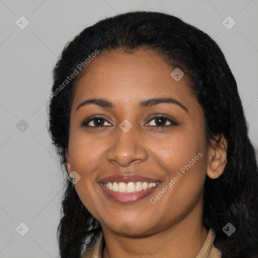 Joyful black young-adult female with long  black hair and brown eyes