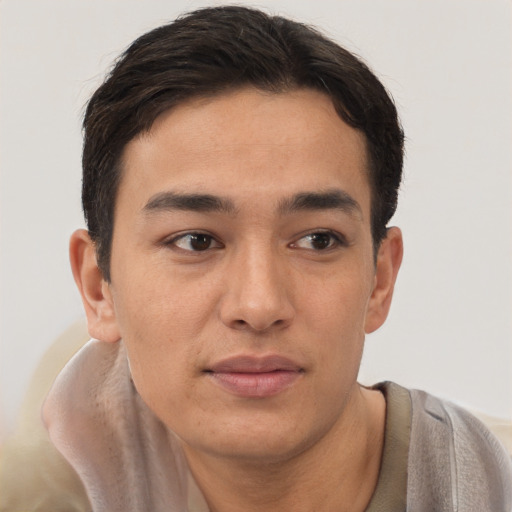 Joyful latino young-adult male with short  brown hair and brown eyes