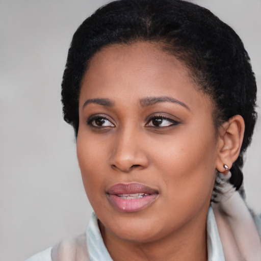 Joyful black young-adult female with short  brown hair and brown eyes