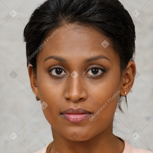 Joyful black young-adult female with short  brown hair and brown eyes