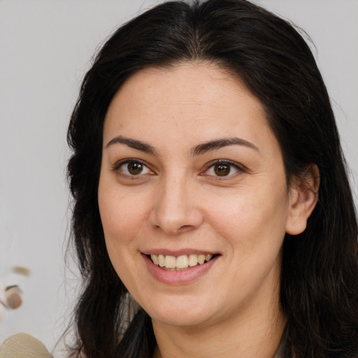 Joyful white young-adult female with long  brown hair and brown eyes