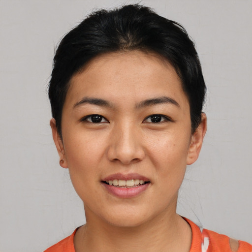 Joyful asian young-adult female with short  black hair and brown eyes