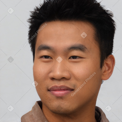 Joyful asian young-adult male with short  black hair and brown eyes