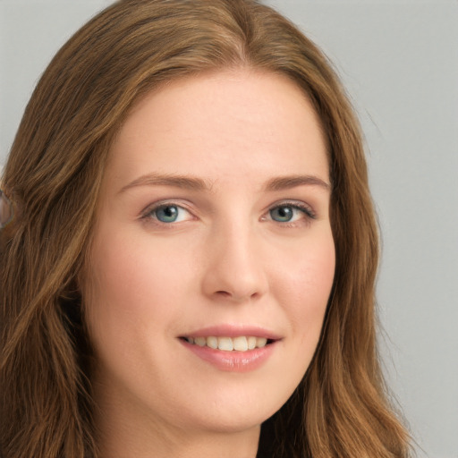 Joyful white young-adult female with long  brown hair and green eyes