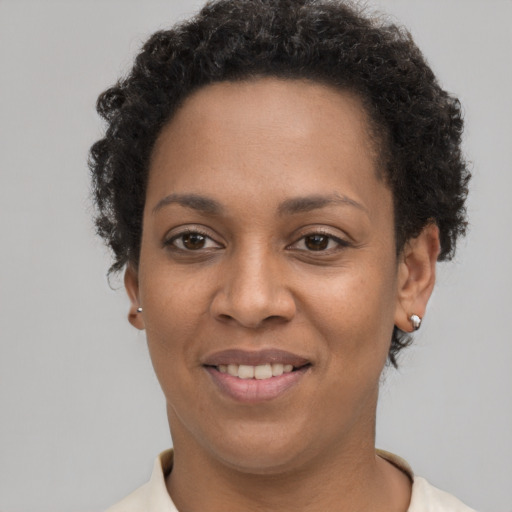 Joyful black young-adult female with short  brown hair and brown eyes