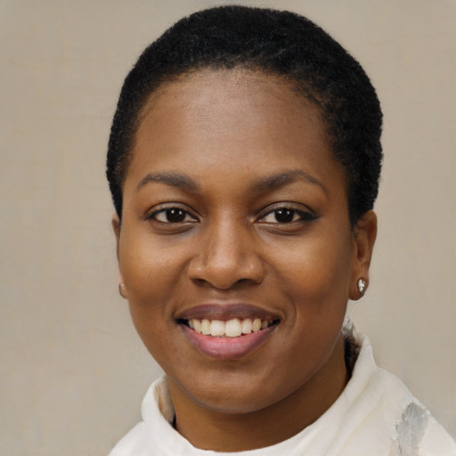 Joyful black young-adult female with short  black hair and brown eyes