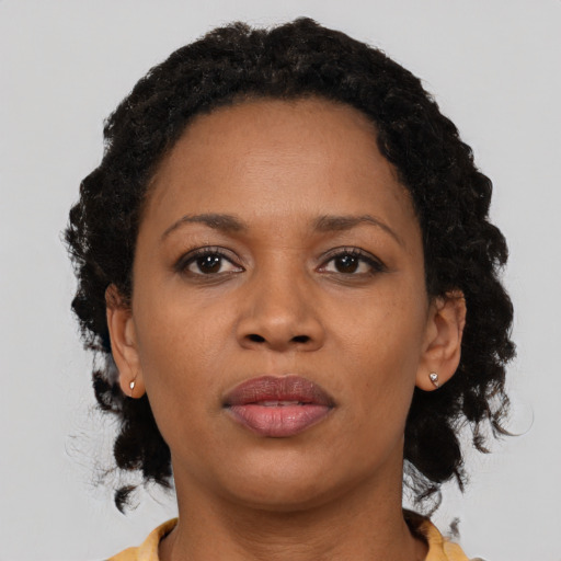 Neutral black young-adult female with medium  brown hair and brown eyes