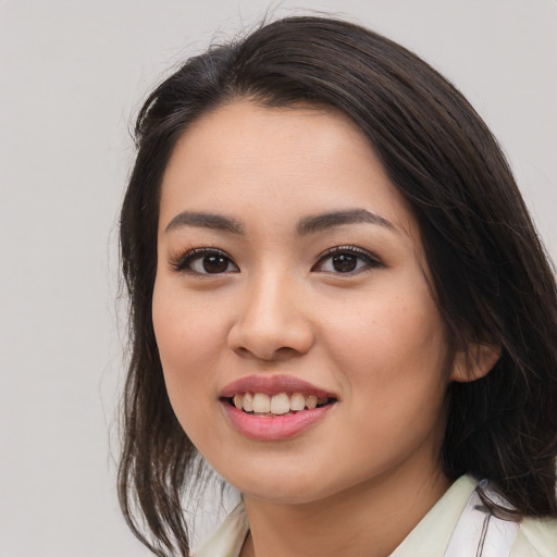 Joyful asian young-adult female with medium  brown hair and brown eyes