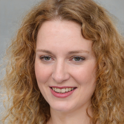 Joyful white young-adult female with medium  brown hair and green eyes