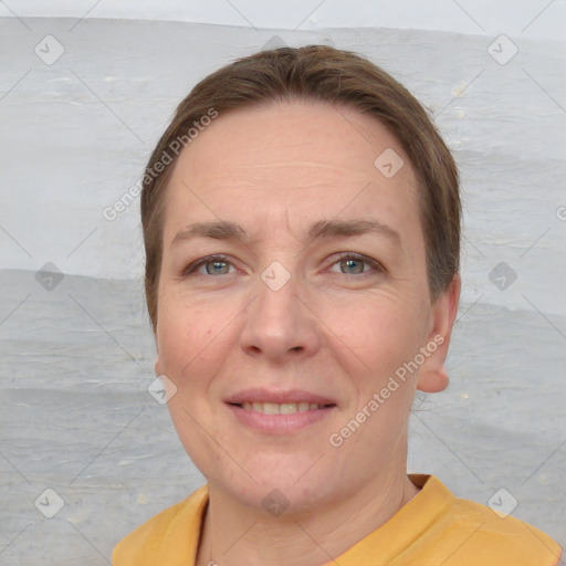 Joyful white adult female with short  brown hair and grey eyes