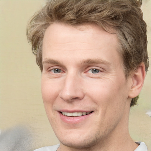 Joyful white adult male with short  brown hair and grey eyes