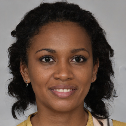 Joyful black young-adult female with medium  brown hair and brown eyes