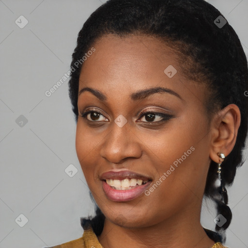 Joyful black young-adult female with long  black hair and brown eyes