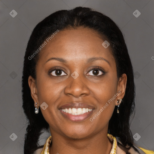 Joyful black young-adult female with long  black hair and brown eyes