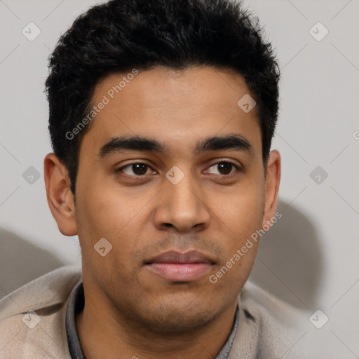 Joyful latino young-adult male with short  brown hair and brown eyes