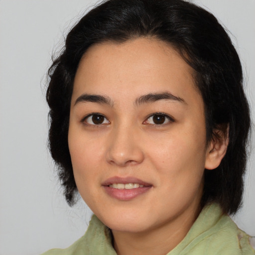 Joyful asian young-adult female with medium  brown hair and brown eyes