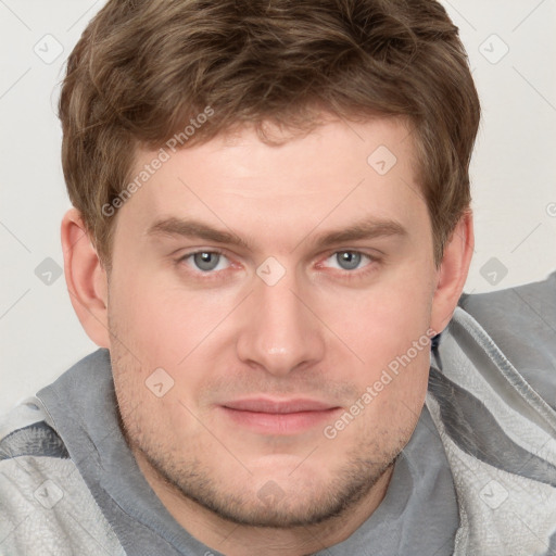 Joyful white young-adult male with short  brown hair and blue eyes