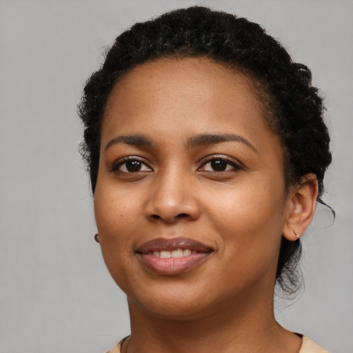 Joyful latino young-adult female with short  black hair and brown eyes